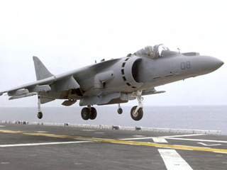 A harrier aircraft above a carrier flight deck. A harrier aircraft above a carrier flight deck.