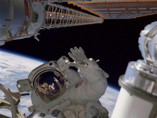 Photo of an astronaut in space with the Earth behind. Photo of an astronaut in space with the Earth behind.