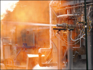 A white-hot flame surrounded by red hot exhaust shoots out from a J-2X engine gas generator. A white-hot flame surrounded by red hot exhaust shoots out from a J-2X engine gas generator.