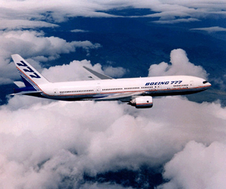 A photograph of a Boeing 777 in flight. A photograph of a Boeing 777 in flight.
