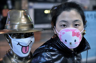 A photo of a girl with a medical face mask featuring a cat. A photo of a girl with a medical face mask featuring a cat.