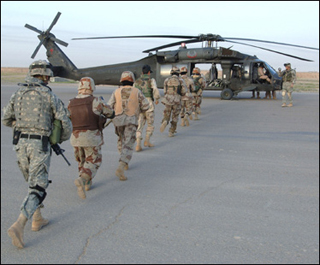 Iraqi soldiers board a Black Hawk helicopter. Iraqi soldiers board a Black Hawk helicopter.