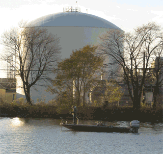 Three photos as an animated gif: a residential neighborhood, a house with a cooling tower in the background, and an industrial tank near a river. Three photos as an animated gif: a residential neighborhood, a house with a cooling tower in the background, and an industrial tank near a river.