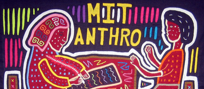 A photograph of a quilt with MIT Anthro stitched alongside two quilted people A photograph of a quilt with MIT Anthro stitched alongside two quilted people