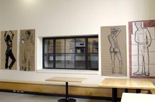 A photo of four body drawings hung on the wall. A photo of four body drawings hung on the wall.