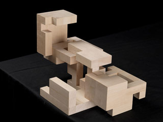 A wooden cube with separating parts in an open position. A wooden cube with separating parts in an open position.