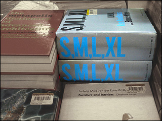 Stacks of books on a table, with the silver-covered books with blue lettering as the focal point. Stacks of books on a table, with the silver-covered books with blue lettering as the focal point.