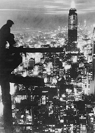 Image of a man sitting high above New York City. Image of a man sitting high above New York City.