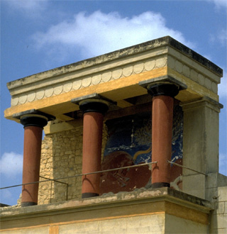 A photo of the Palace of Minos in Crete, specifically a balcony with three columns in front of a painted wall. A photo of the Palace of Minos in Crete, specifically a balcony with three columns in front of a painted wall.