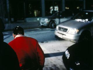 Photo of a man crossing the street. Photo of a man crossing the street.