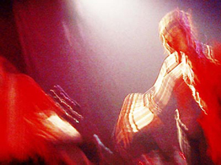 A motion blurry photo of two performers on stage. A motion blurry photo of two performers on stage.