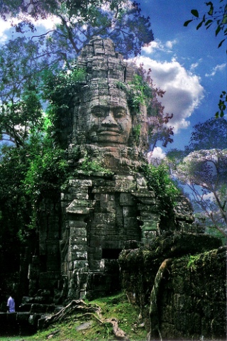 Photograph of a tower with carved face, part of the Angkor city gates. Photograph of a tower with carved face, part of the Angkor city gates.