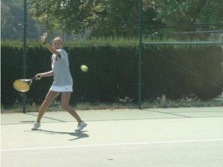 An MIT tennis team member hits a forehand. An MIT tennis team member hits a forehand.