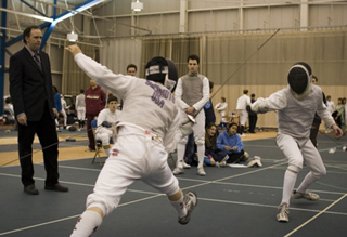 MIT fencer attacks his opponent. MIT fencer attacks his opponent.