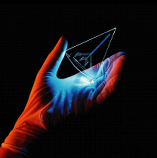 Photo of a small glass chip DNA sequencing device. Photo of a small glass chip DNA sequencing device.
