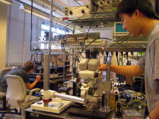 Students working on lab apparatus. Students working on lab apparatus.