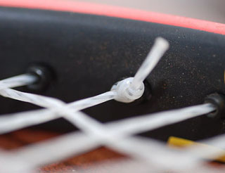 Photo of the edge of a tennis racket. Photo of the edge of a tennis racket.