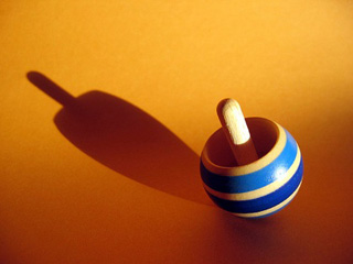Toy top, tilted while spinning Toy top, tilted while spinning