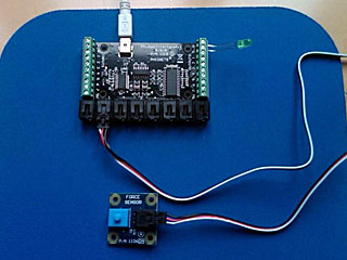 One big and one small circuit board placed on a blue surface with attached wires One big and one small circuit board placed on a blue surface with attached wires
