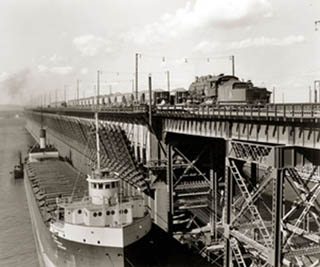 Black and white photo of a ship at an iron ore docks. Black and white photo of a ship at an iron ore docks.