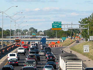 A photo of a traffic jam on a three lane highway. A photo of a traffic jam on a three lane highway.