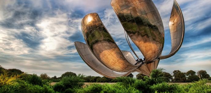 A 75-foot tall metal sculpture of a flower, standing in the middle of a park. A 75-foot tall metal sculpture of a flower, standing in the middle of a park.