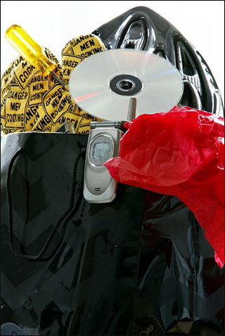Photograph of shopping bag with consumer goods overflowing. Photograph of shopping bag with consumer goods overflowing.