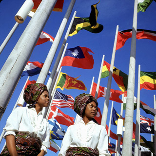 Two young women in front of flags at Place des Nations, Expo 67, on opening day. Two young women in front of flags at Place des Nations, Expo 67, on opening day.