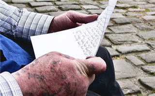 Hands holding a piece of paper. Hands holding a piece of paper.
