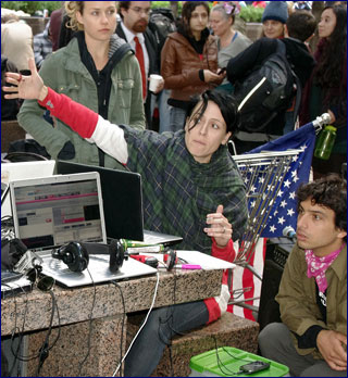 Scene from the Occupy Wall Street protests of people around a table covered with laptops and cell phones. Scene from the Occupy Wall Street protests of people around a table covered with laptops and cell phones.