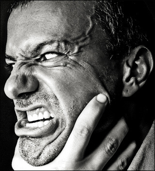 A grimace of rage with a hand around the throat. A grimace of rage with a hand around the throat.