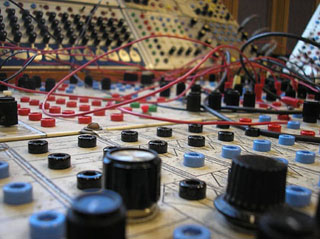 Closeup of knobs, dials and wires on an analog synthesizer. Closeup of knobs, dials and wires on an analog synthesizer.
