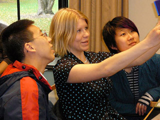 Photo of three students working on a handheld videogame. Photo of three students working on a handheld videogame.