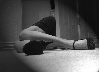 A black and white photo of an obscured woman on the ground (looking as though she is dead). A black and white photo of an obscured woman on the ground (looking as though she is dead).