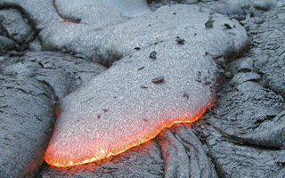 Image of a pillow basalt formation glowing red. Image of a pillow basalt formation glowing red.