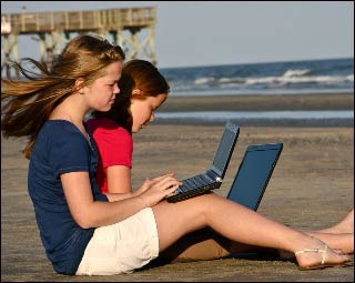Two girls working on the beach. Two girls working on the beach.