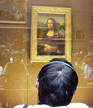 A photograph of the Mona Lisa taken at the Louvre. Crowds of people can be seen in the reflection of the glass that encases the painting. A photograph of the Mona Lisa taken at the Louvre. Crowds of people can be seen in the reflection of the glass that encases the painting.