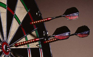Photograph of darts in a dart board. Photograph of darts in a dart board.