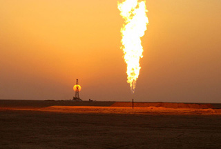 Oil rig and flare at sunset. Oil rig and flare at sunset.