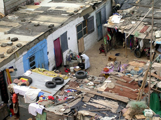 Photo of a group of flimsy makeshift housing for poor families in Ghana. Photo of a group of flimsy makeshift housing for poor families in Ghana.