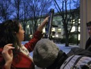 Photo of students viewing the moon through a small telescope.