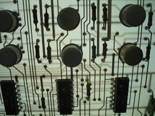 A photo of a backlit printed circuit board. A photo of a backlit printed circuit board.