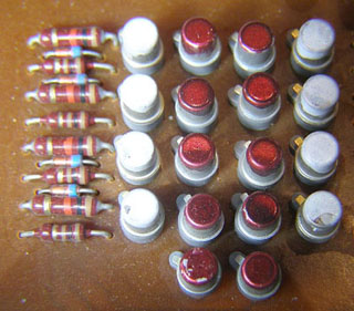 Transistors and resistors on an old memory board. Transistors and resistors on an old memory board.