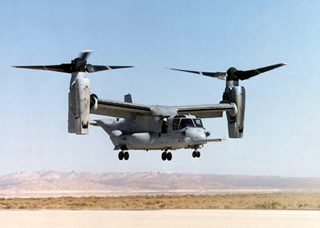 A photo of an CV-22 Osprey in rotorcraft mode, hovering above the ground. A photo of an CV-22 Osprey in rotorcraft mode, hovering above the ground.