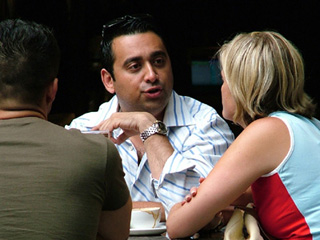 Three friends chat at a coffee shop. Three friends chat at a coffee shop.