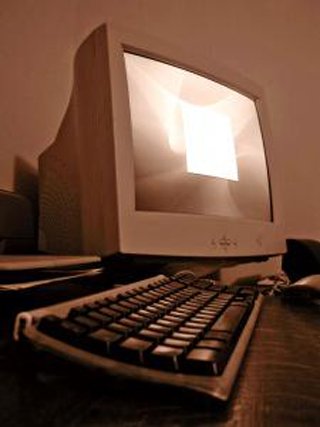 A sepia toned photograph of a personal computer. A sepia toned photograph of a personal computer.