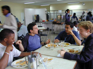 Students having a conversation in a cafeteria. Students having a conversation in a cafeteria.