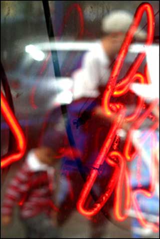 Figures reflected in a Chinatown shop window, in Boston, MA. Figures reflected in a Chinatown shop window, in Boston, MA.