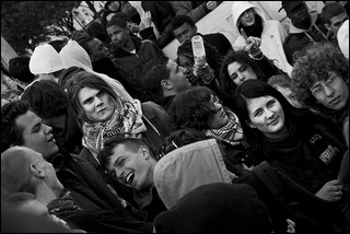 Black and white photo of a small crowd of high school age boys and girls talking and laughing among themselves. Black and white photo of a small crowd of high school age boys and girls talking and laughing among themselves.