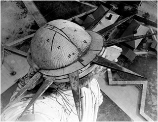 Aerial view of the Statue of Liberty in New York, the angle from the above her head accentuating the shape of the iconic headress. Aerial view of the Statue of Liberty in New York, the angle from the above her head accentuating the shape of the iconic headress.